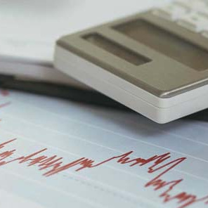 calculator and business graphs on a table