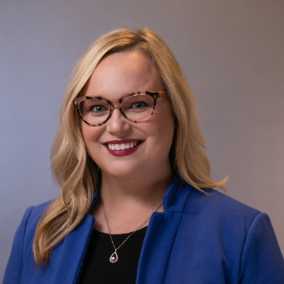women in glasses and blue blazer