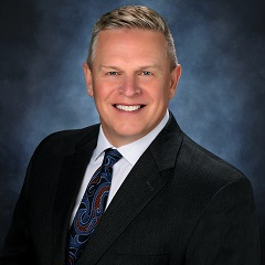 Jim in a suit and tie