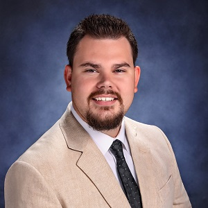 Drew Roy in a suit and tie