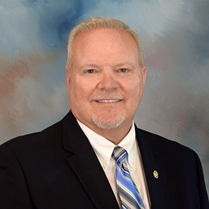 Fred Osborn in a suit and tie